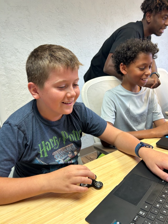 Kids learning to code at the Academy